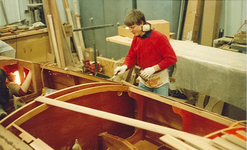 Craftsman, Dave, applying epoxy to planking of runabout Flicker.